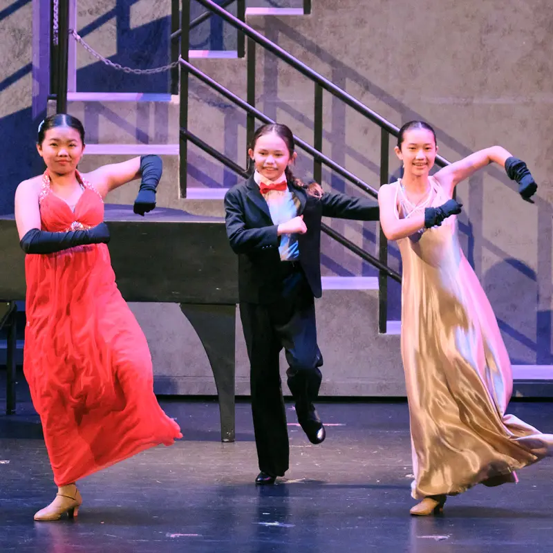 Two children on stage acting in Beauty and the Beast