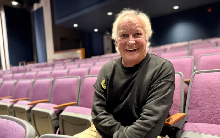 John Rampage sitting in theater seats