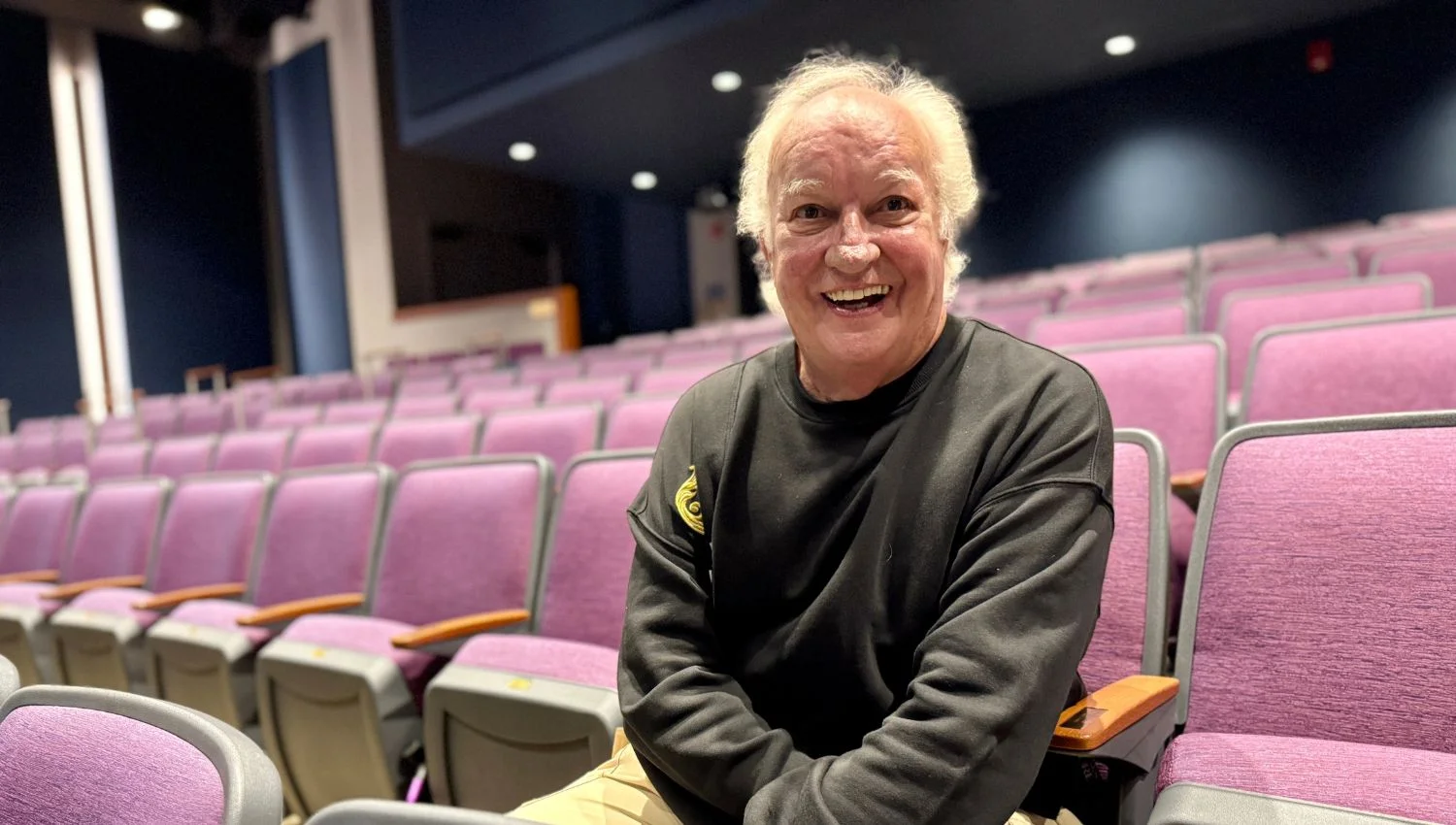 John Rampage sitting in theater seats